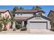 Charming two-story home featuring a well-maintained front yard and attached two-car garage at 15955 N Cristine Ln, Surprise, AZ 85388