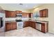 Spacious kitchen features stainless steel appliances, granite counters, and custom cabinets at 15955 N Cristine Ln, Surprise, AZ 85388