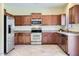 Modern kitchen featuring stainless steel appliances, ample counter space, and tile floors at 15955 N Cristine Ln, Surprise, AZ 85388