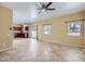 Open living area with windows and tile flooring, connected to a kitchen with wood cabinetry at 15955 N Cristine Ln, Surprise, AZ 85388