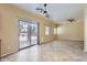 Open floor plan with tile flooring and access to backyard through sliding glass door at 15955 N Cristine Ln, Surprise, AZ 85388