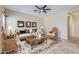 Elegantly staged living room featuring sophisticated decor, and stylish furnishings on tile flooring at 15955 N Cristine Ln, Surprise, AZ 85388