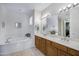 Well-lit bathroom features a garden tub, double vanity, and tile floors at 16364 E Ridgeline Dr, Fountain Hills, AZ 85268