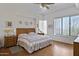 Comfortable bedroom features a ceiling fan, large windows, and stylish, rustic-style decor at 16364 E Ridgeline Dr, Fountain Hills, AZ 85268
