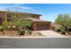 Exterior view of a home with desert landscaping, driveway, and an attached garage at 16364 E Ridgeline Dr, Fountain Hills, AZ 85268
