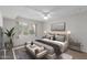 Bedroom featuring a large window, white brick accent wall, and stylish decor at 16852 E La Montana Dr # C18, Fountain Hills, AZ 85268