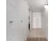 Bright hallway featuring white doors with decorative knobs and a peek into the kitchen at 16852 E La Montana Dr # C18, Fountain Hills, AZ 85268