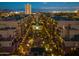 Nighttime aerial view of upscale condo community with central courtyard, sparkling pool, and city lights at 17 W Vernon Ave # 508, Phoenix, AZ 85003