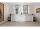 Bright bathroom with dual sinks, storage, and tiled floors at 17 W Vernon Ave # 508, Phoenix, AZ 85003