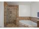 Bathroom boasting a glass shower with tile surround and a soaking tub with tile accents at 17 W Vernon Ave # 508, Phoenix, AZ 85003