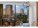Dining room showcasing an urban landscape of city buildings and palm trees during a colorful sunset at 17 W Vernon Ave # 508, Phoenix, AZ 85003