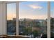 Balcony view showcasing an urban landscape with buildings and trees during a colorful sunset at 17 W Vernon Ave # 508, Phoenix, AZ 85003