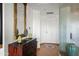Bright hallway features a decorative mirror and chest, with tiled floor and a patterned glass wall at 17 W Vernon Ave # 508, Phoenix, AZ 85003
