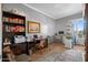Well-appointed home office with built-in bookcase, desk, and a cozy sitting area at 17 W Vernon Ave # 508, Phoenix, AZ 85003