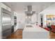 A bright open kitchen features a large island, modern white cabinets, and stainless steel appliances at 17 W Vernon Ave # 508, Phoenix, AZ 85003