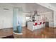 Open-concept kitchen with stainless appliances, a waterfall island with seating, and statement glass wall at 17 W Vernon Ave # 508, Phoenix, AZ 85003