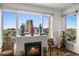 Living room with fireplace features large windows with city views and stylish decor at 17 W Vernon Ave # 508, Phoenix, AZ 85003