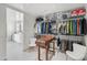 Large walk-in closet with custom storage, shelving, and drawers with ensuite bathroom at 17 W Vernon Ave # 508, Phoenix, AZ 85003