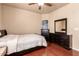 Comfortable bedroom featuring hardwood floors and classic dark furniture at 17153 W Gambit Trl, Surprise, AZ 85387