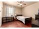 Cozy bedroom with hardwood floors and a ceiling fan at 17153 W Gambit Trl, Surprise, AZ 85387