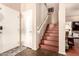 Entryway featuring stylish tile flooring, staircase, and decorative rug at 17153 W Gambit Trl, Surprise, AZ 85387