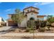 Two-story home with stucco siding, tile roof, arched window, and low-maintenance landscaping at 17153 W Gambit Trl, Surprise, AZ 85387