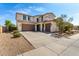 Inviting two-story home with a spacious driveway, dual garage, and well-maintained desert landscaping at 17153 W Gambit Trl, Surprise, AZ 85387