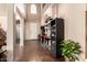 Grand foyer with soaring ceilings, stylish tile flooring, and elegant bar area at 17153 W Gambit Trl, Surprise, AZ 85387