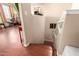Bright hallway features hardwood floors, staircase and access to a home gym or bonus space at 17153 W Gambit Trl, Surprise, AZ 85387