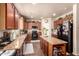 Modern kitchen with granite countertops, center island, stainless appliances, and tile flooring at 17153 W Gambit Trl, Surprise, AZ 85387