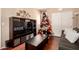 Living room features a large entertainment center and a decorated Christmas tree at 17153 W Gambit Trl, Surprise, AZ 85387