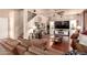Comfortable living room with sectional sofa, media center, and stylish decor throughout at 17153 W Gambit Trl, Surprise, AZ 85387