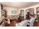 Bright living room with hardwood floors, neutral walls, ample seating, and decorative wall art at 17153 W Gambit Trl, Surprise, AZ 85387