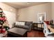 Neutral living room with a comfortable grey couch, large clock, and office space at 17153 W Gambit Trl, Surprise, AZ 85387