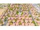 Expansive aerial view showcases the community layout with pools, streets, desert landscaping and a beautiful mountain backdrop at 17606 N 17Th Pl # 1096, Phoenix, AZ 85022