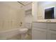 Bathroom with neutral tile, built-in storage, and bathtub with shower at 17606 N 17Th Pl # 1096, Phoenix, AZ 85022