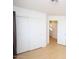 Bright bedroom features neutral walls, light-colored wood floor, and closet with sliding doors at 17606 N 17Th Pl # 1096, Phoenix, AZ 85022