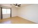 The bedroom has a ceiling fan, neutral paint, wood floor, and a window to let in natural light at 17606 N 17Th Pl # 1096, Phoenix, AZ 85022
