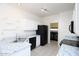 Kitchen features white cabinets, granite countertops, black appliances, and tile flooring at 17606 N 17Th Pl # 1096, Phoenix, AZ 85022