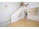 Bright living room features vaulted ceilings, light-colored wood floors, and a staircase with built-in storage at 17606 N 17Th Pl # 1096, Phoenix, AZ 85022