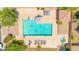 Aerial view of a community swimming pool area, complete with lounge chairs and desert landscaping at 17606 N 17Th Pl # 1096, Phoenix, AZ 85022