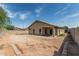 Wide backyard view with covered patio, showcasing potential for landscaping and outdoor enjoyment at 17828 W Calavar Rd, Surprise, AZ 85388
