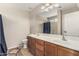 Bathroom with a dual sink vanity, large mirror, and a separate shower/tub area at 17828 W Calavar Rd, Surprise, AZ 85388