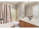 Cozy bathroom featuring a shower-tub combination, neutral curtains and modern vanity sink at 17828 W Calavar Rd, Surprise, AZ 85388