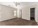 Bright bedroom with neutral walls, a ceiling fan, and views of the backyard at 17828 W Calavar Rd, Surprise, AZ 85388
