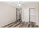 Well-lit bedroom with stylish plank flooring and closet doors; offers ample storage space at 17828 W Calavar Rd, Surprise, AZ 85388