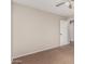 Standard bedroom featuring neutral walls and carpet, equipped with ceiling fan and white door at 17828 W Calavar Rd, Surprise, AZ 85388