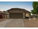 Charming single story home featuring low maintenance desert landscaping and a two car garage at 17828 W Calavar Rd, Surprise, AZ 85388