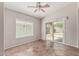 Cozy living area features a sliding glass door to the outside, ceiling fan and tile floors at 17828 W Calavar Rd, Surprise, AZ 85388