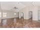Spacious living room with tile flooring, ceiling fan, and plenty of natural light from multiple windows at 17828 W Calavar Rd, Surprise, AZ 85388